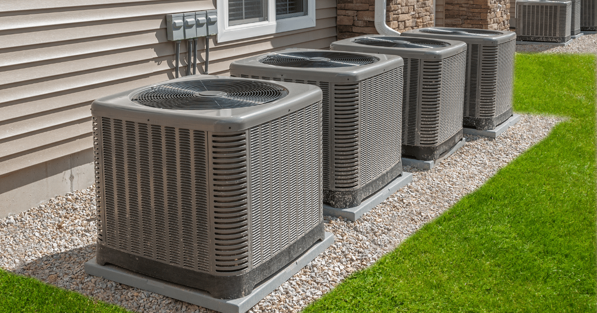 a group of air conditioning units outside a house
