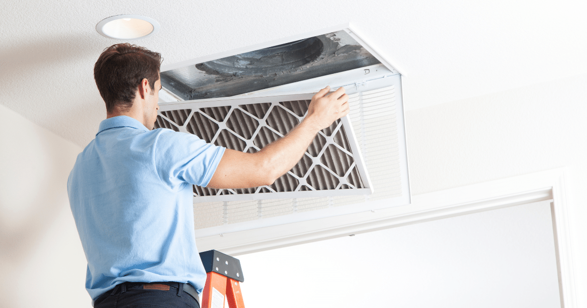 a man cleaning a air filter
