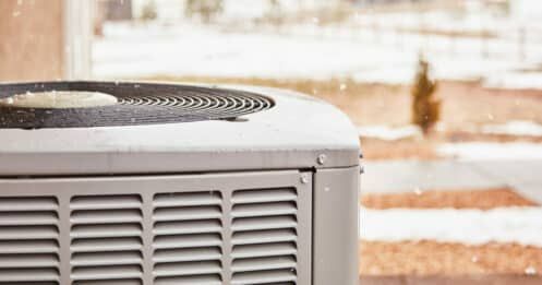 Residential air conditioning unit with snow in winter.